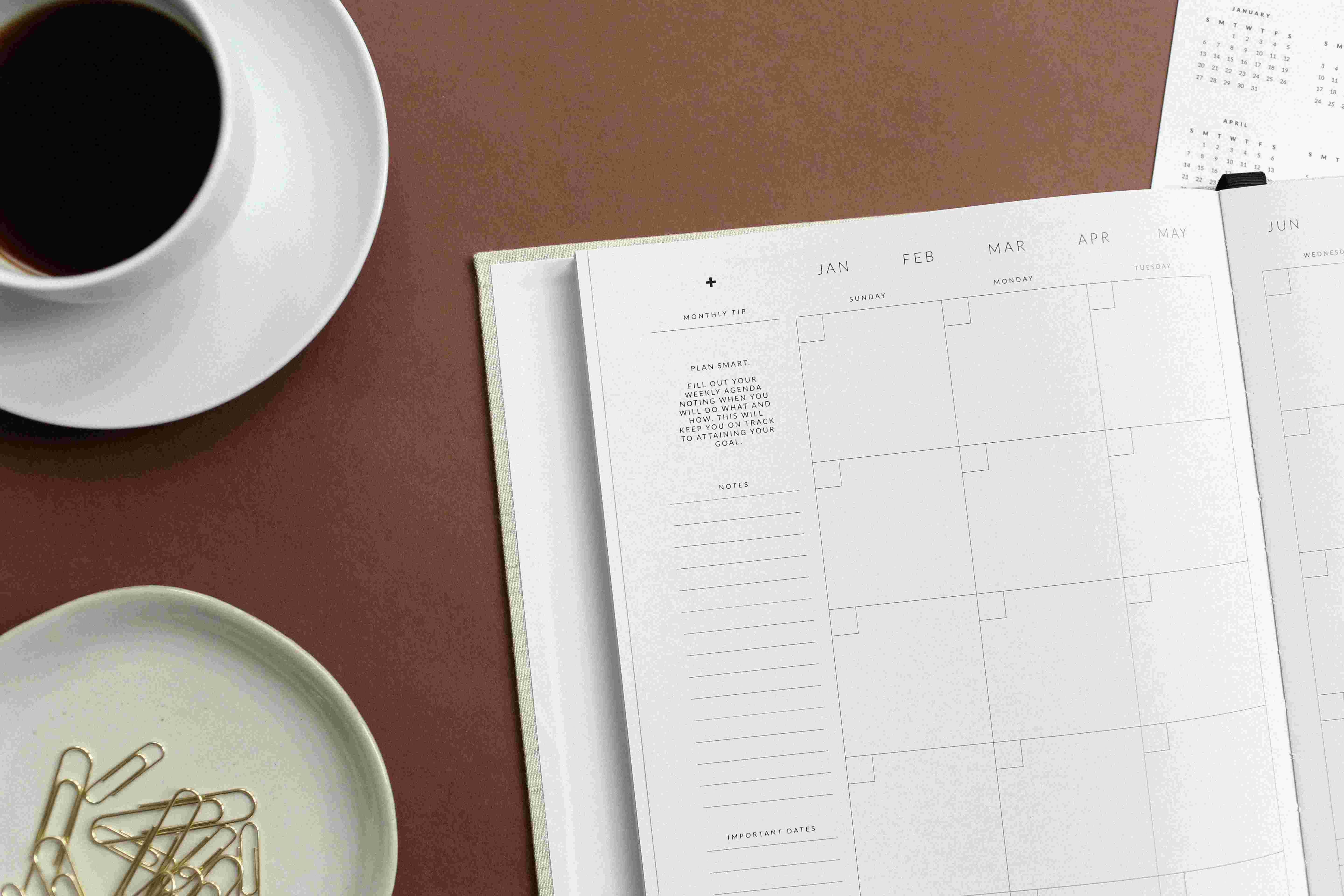 A phone resting beside a teacup on a wooden table, a quiet moment of reaching out