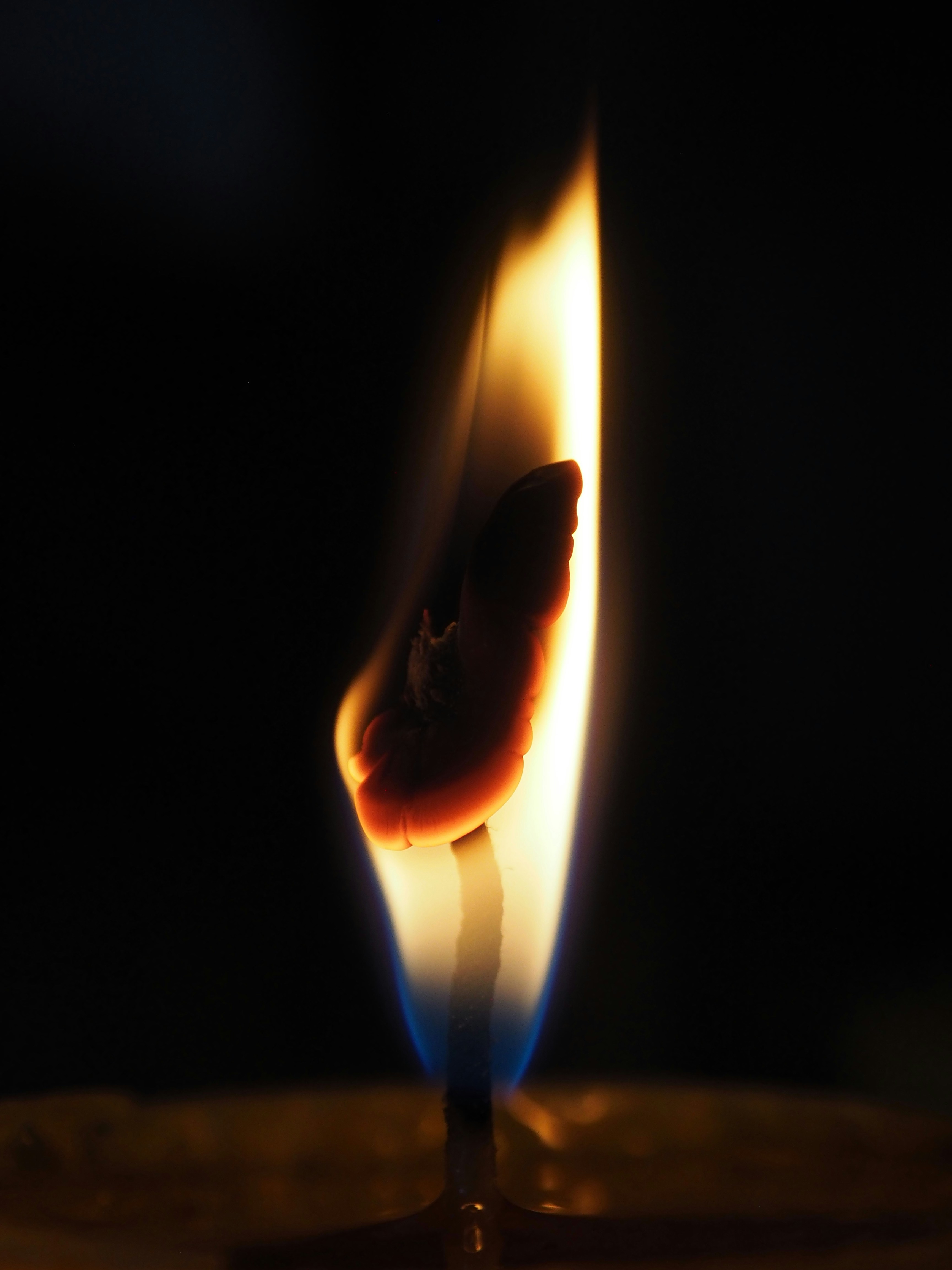 A single candle flame burning in darkness &ndash; the structure that the practice slowly extinguishes