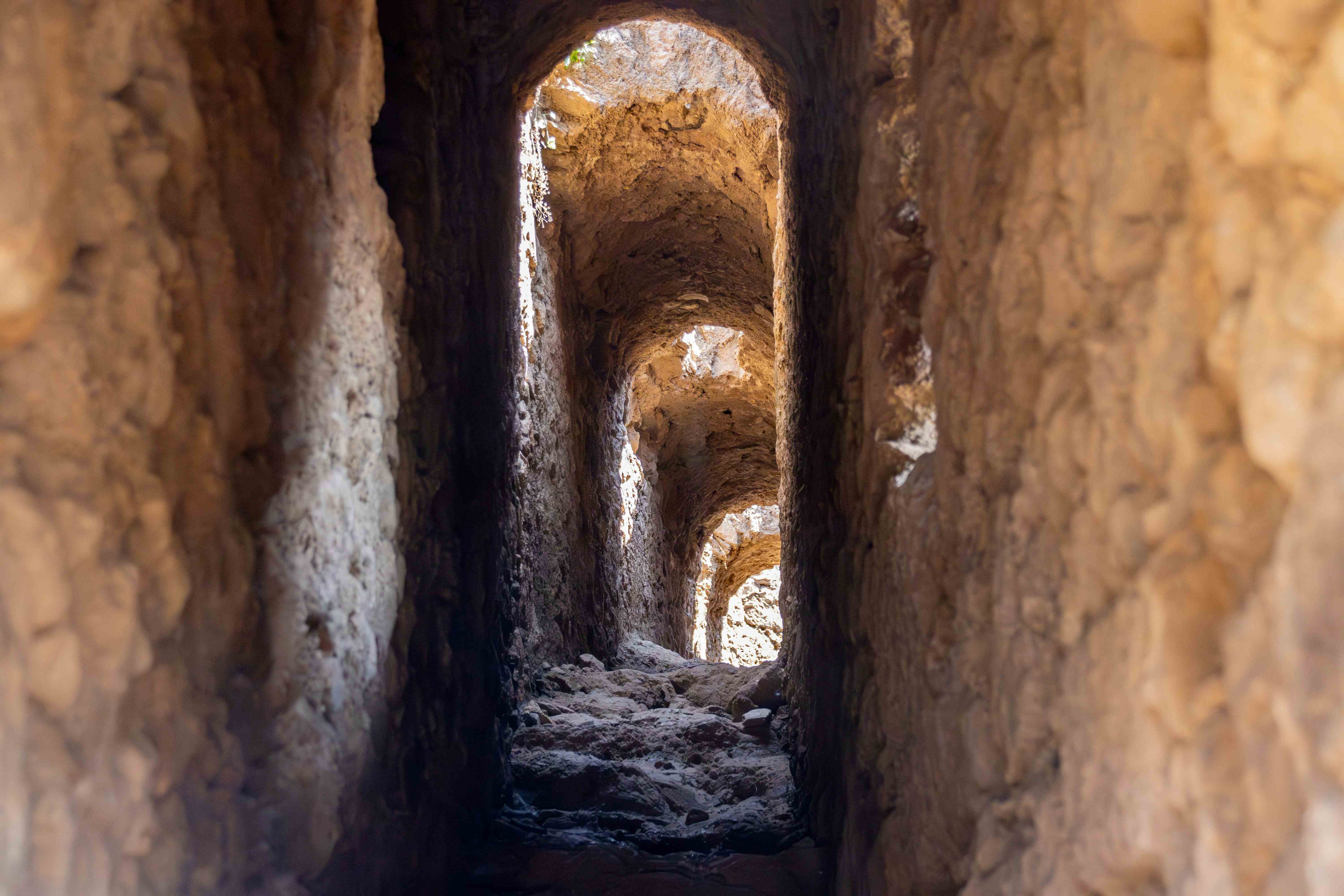 Ancient stone tunnel with arched doorways &ndash; the threshold that holds