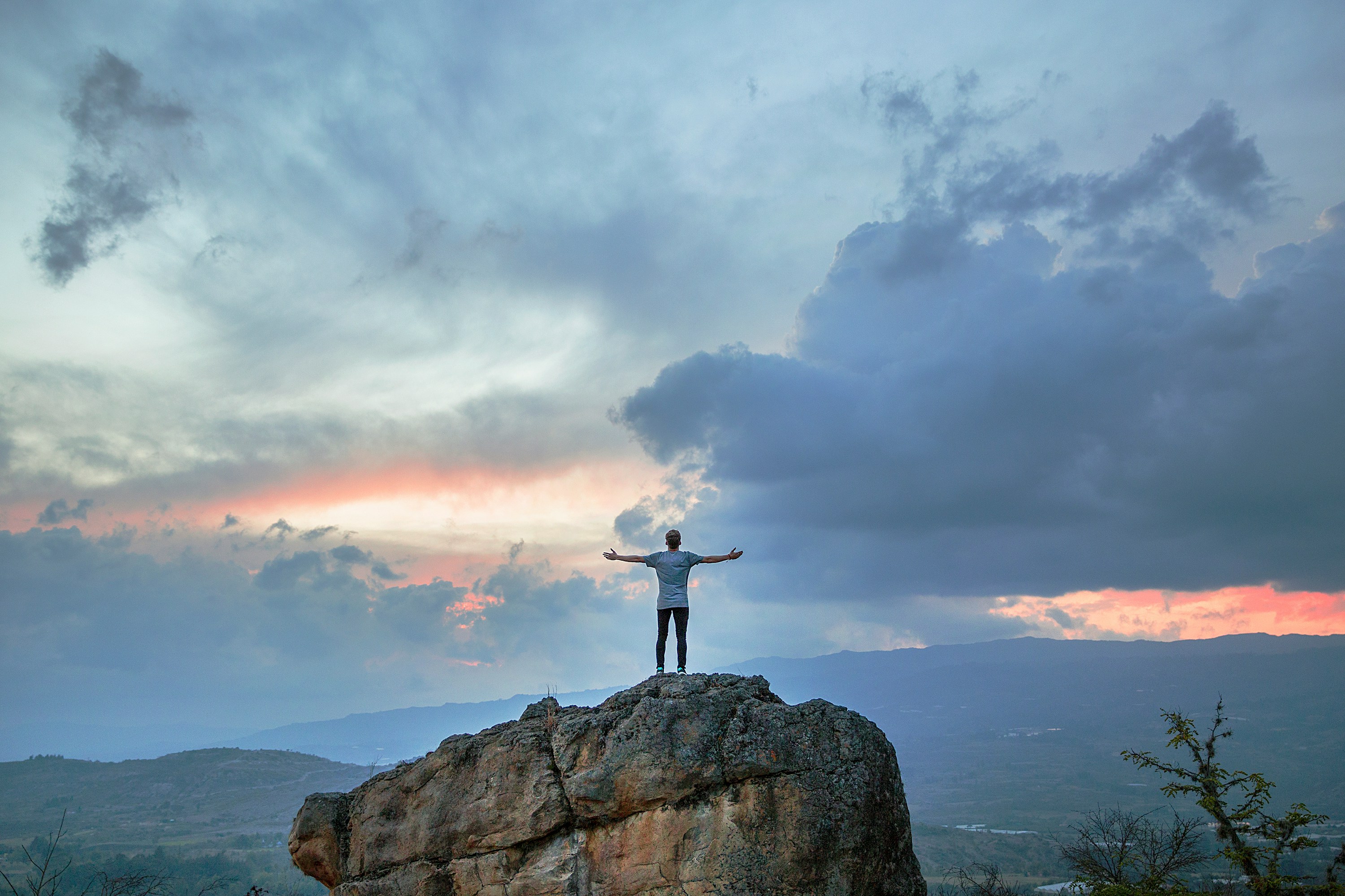 A person standing in open landscape at morning light